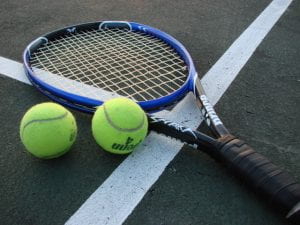 A tennis ball and racket